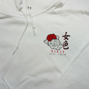 Close up view of Mikan Est, 2020 with red and white roses on the font of white hoodie