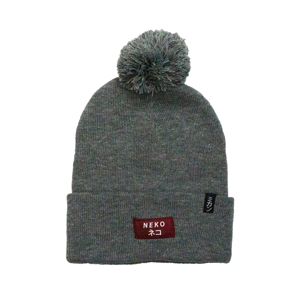 gray POM beanie with a red tag that says NEKO and  black tag that says MIkan in katakana